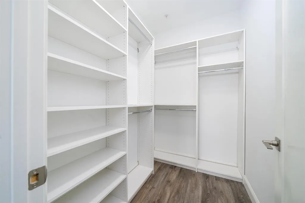 a view of walk in closet with empty racks