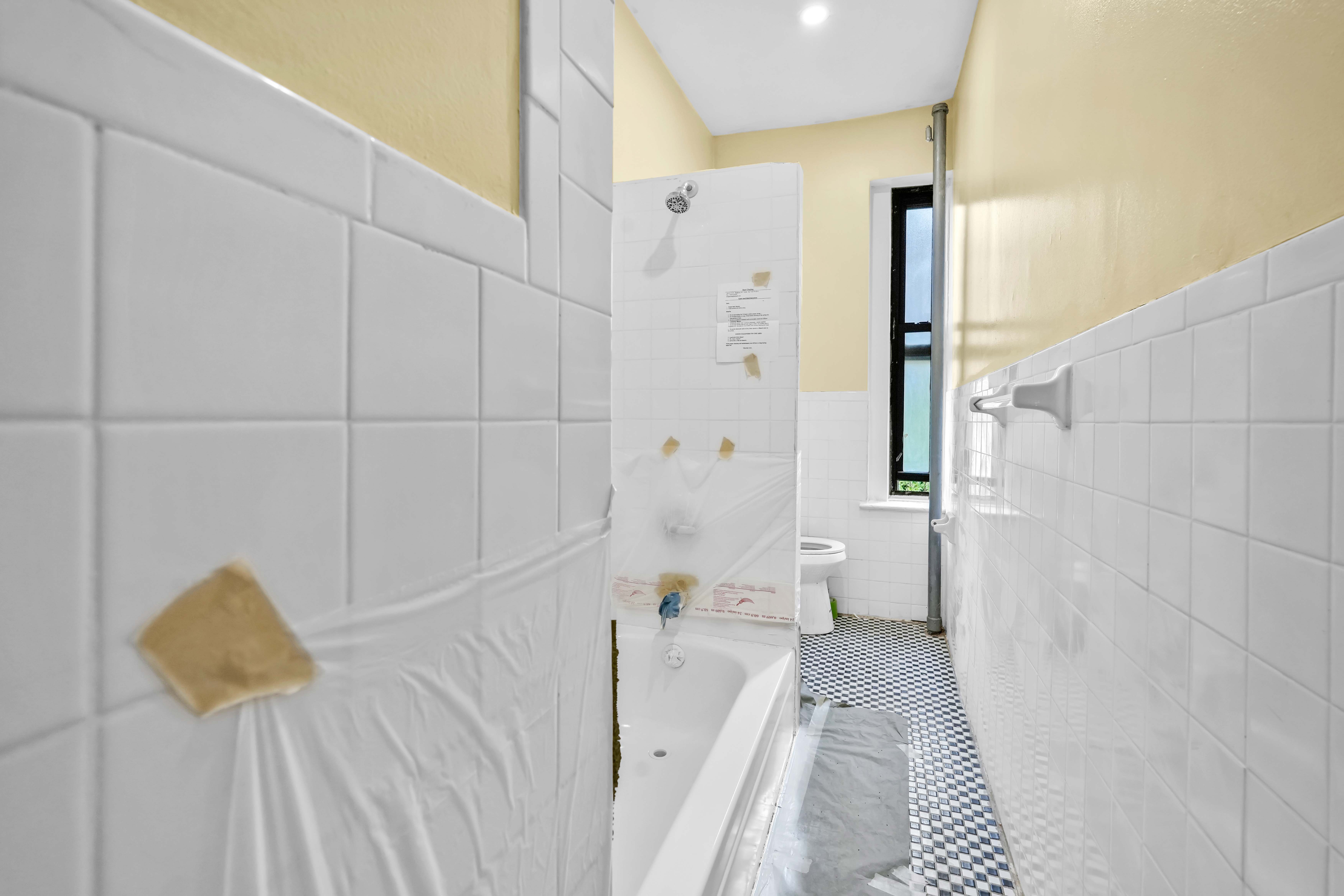 1770 Bedford Avenue Brooklyn, NY 11225 - Photo 26 of 50 a bathroom with a bathtub and a shower