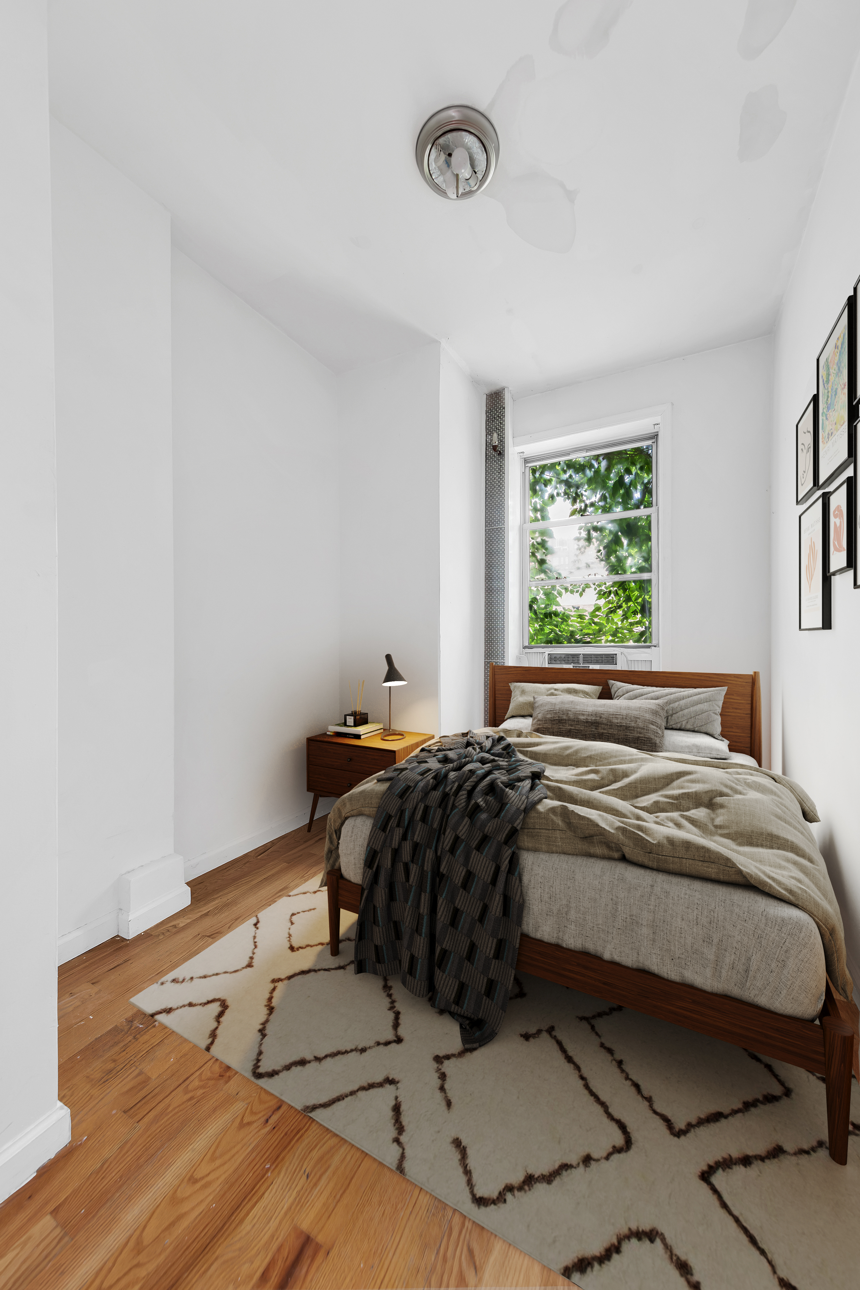 205 West 20th Street, Unit 2W Manhattan, NY 10011 - Photo 4 of 5 a bedroom with a bed and window