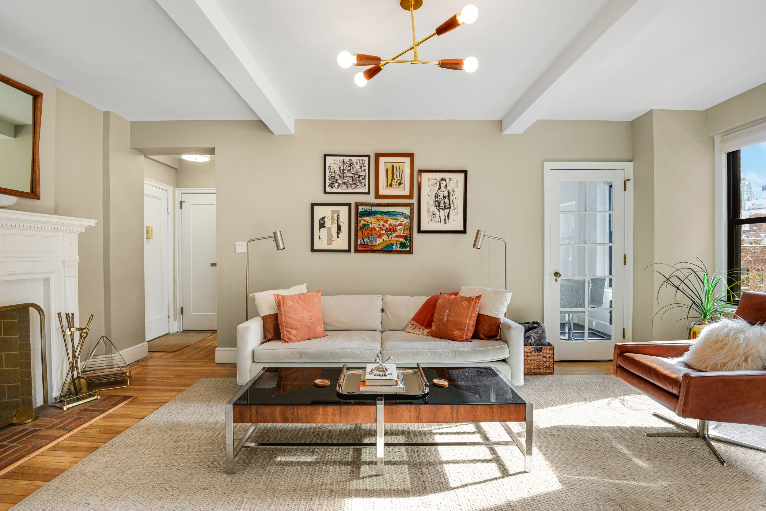a living room with furniture a rug and a fireplace