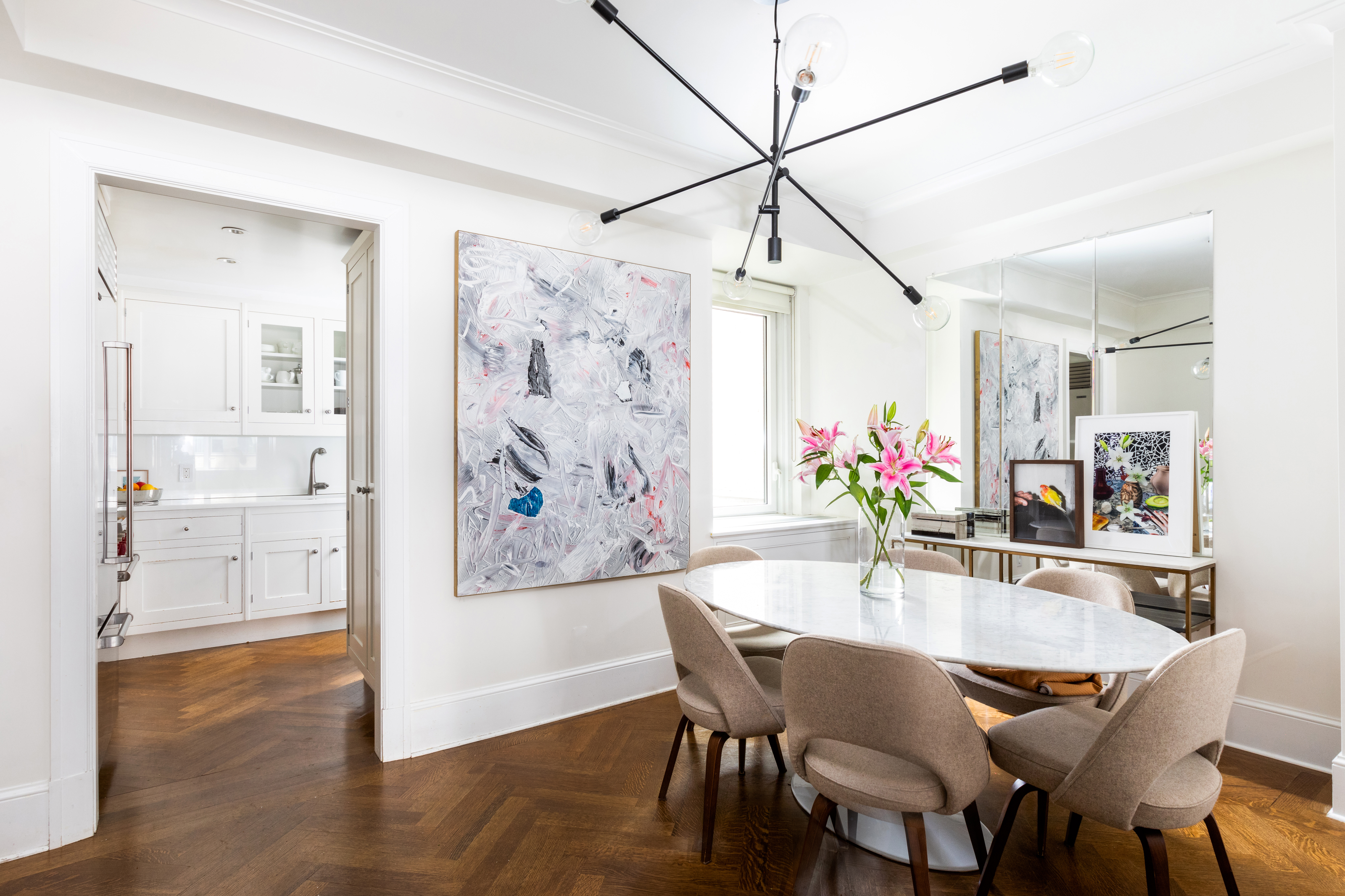 530 Park Avenue, Unit 7G Manhattan, NY 10065 - Photo 4 of 16 a dining room with furniture and wooden floor