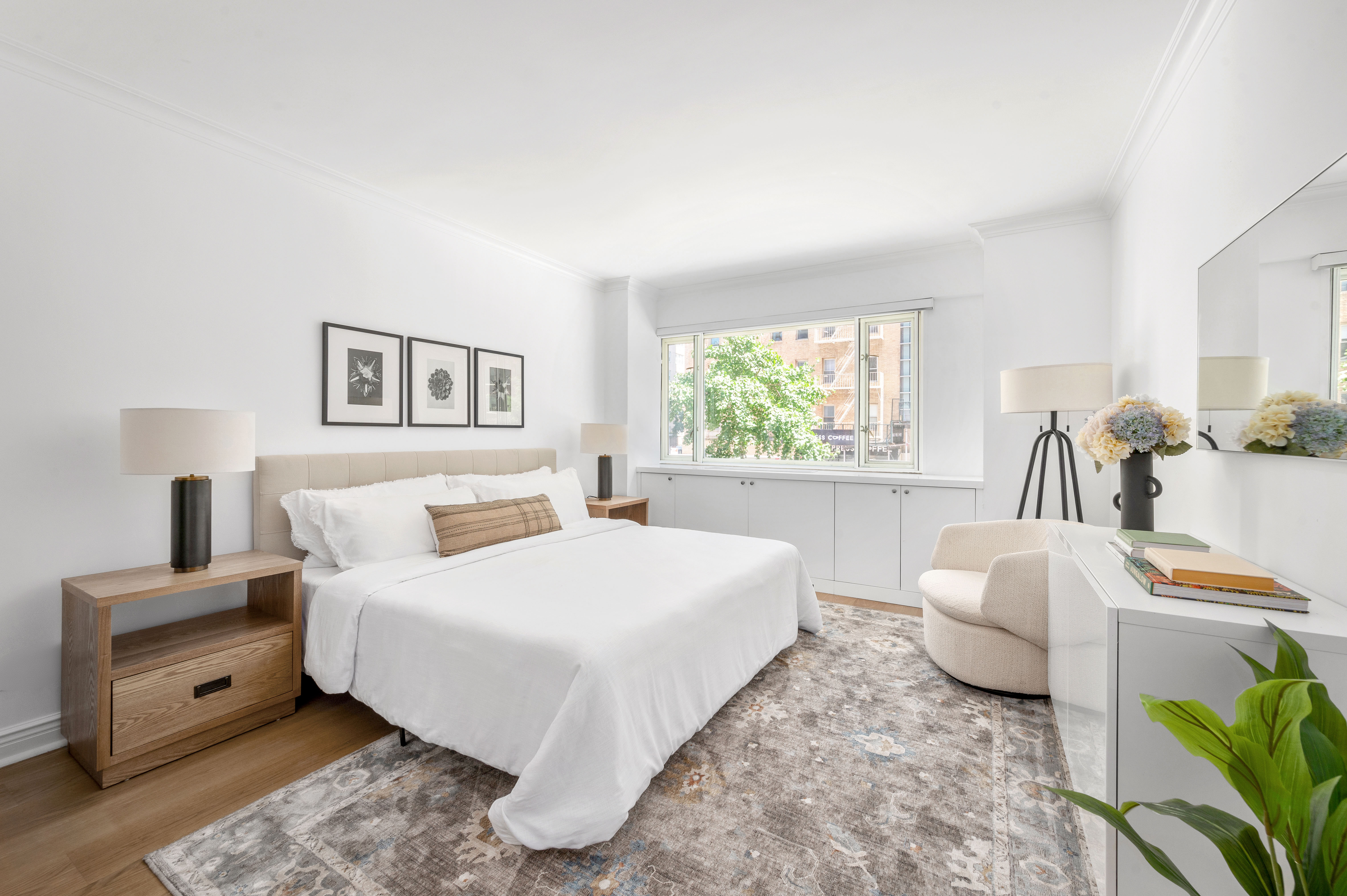 166 East 63rd Street, Unit 2J Manhattan, NY 10065 - Photo 10 of 14 a bedroom with a bed and a couch