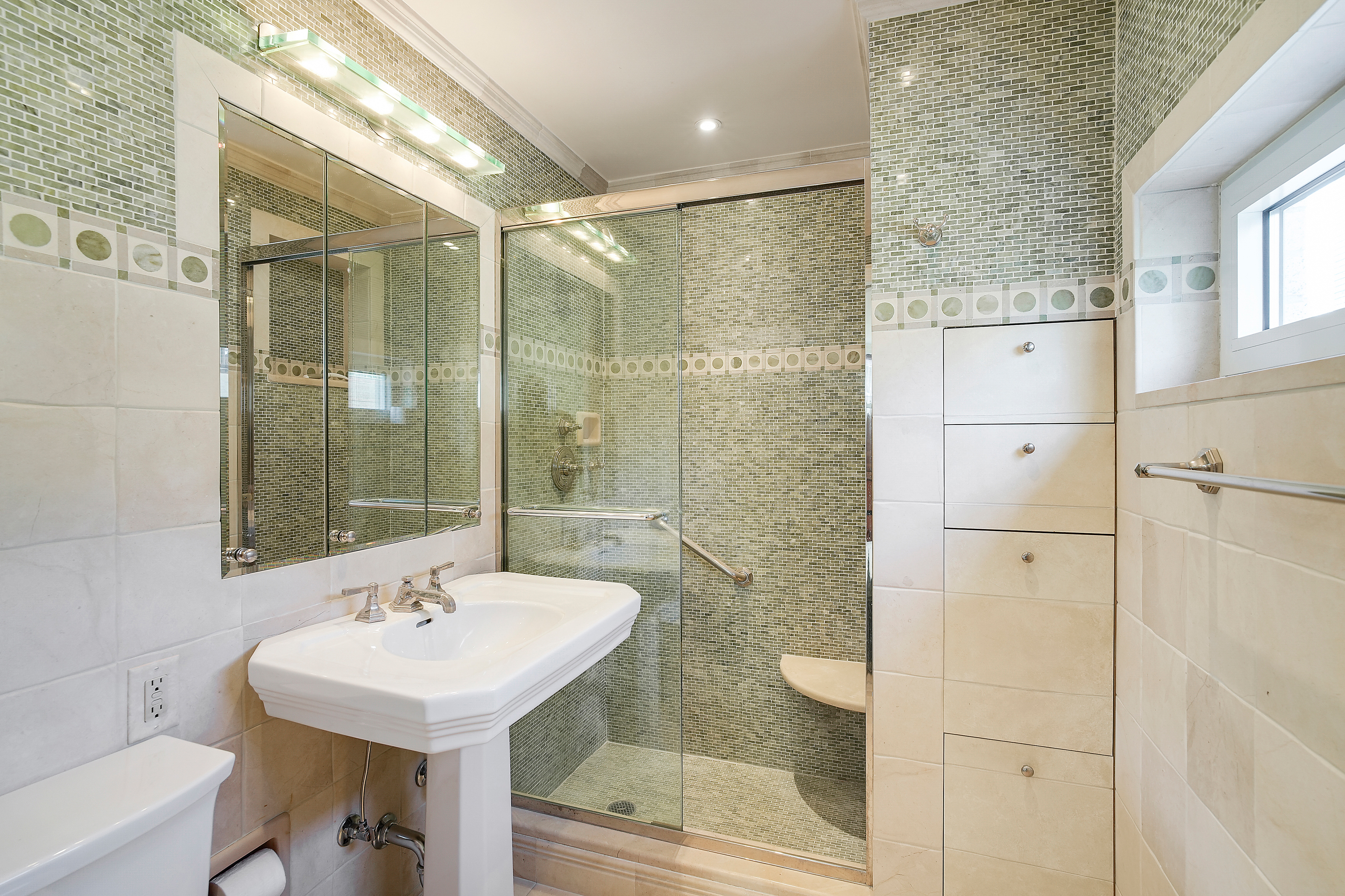 175 East 62nd Street, Unit 8D Manhattan, NY 10065 - Photo 18 of 24 a bathroom with a shower sink and mirror