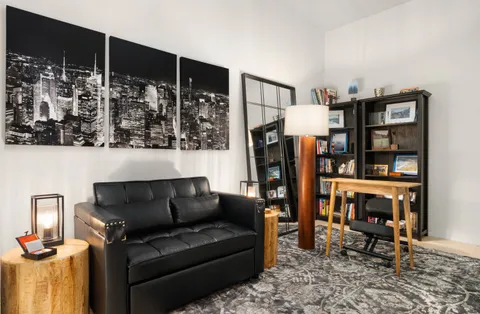 a living room with furniture a rug and a table
