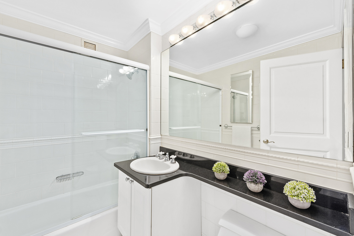 400 East 90th Street, Unit 8E Manhattan, NY 10128 - Photo 5 of 6 a bathroom with a sink and a bathtub