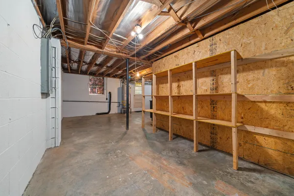 a view of empty room with wooden walls