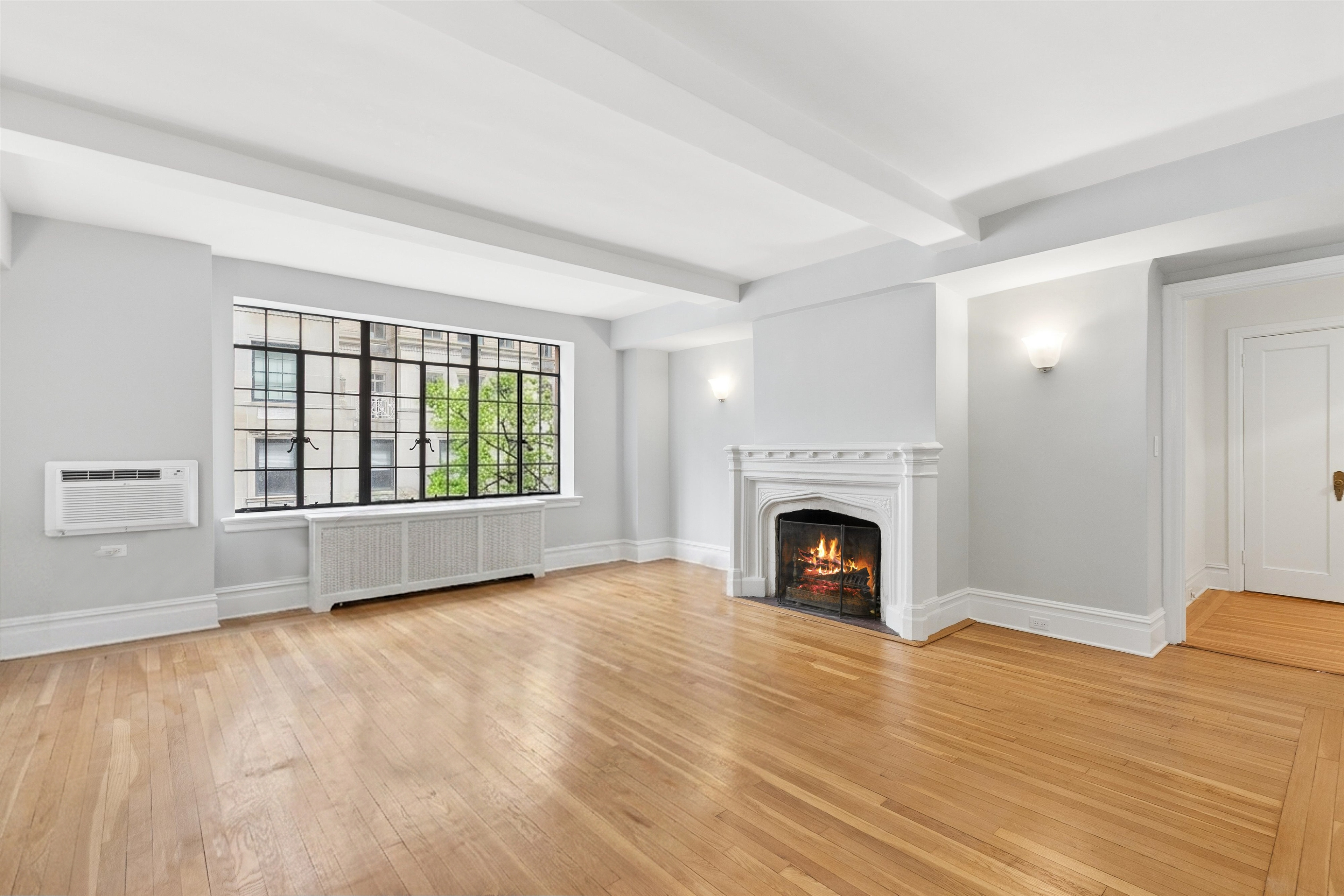 444 East 52nd Street, Unit 3C Manhattan, NY 10022 - Photo 2 of 19 a view of an empty room with window and fire place