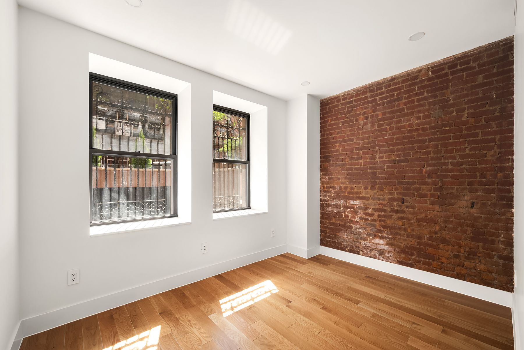 61 West 70th Street, Unit 1A Manhattan, NY 10023 - Photo 5 of 15 a view of an empty room with wooden floor and a window