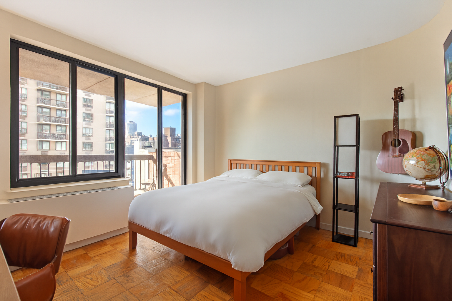 1441 3rd Avenue, Unit 14AB Manhattan, NY 10028 - Photo 11 of 16 a bedroom with a bed and window