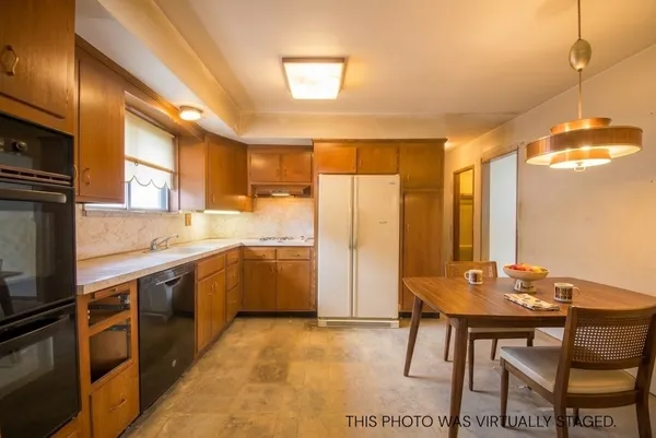 a kitchen with a sink cabinets and stainless steel appliances