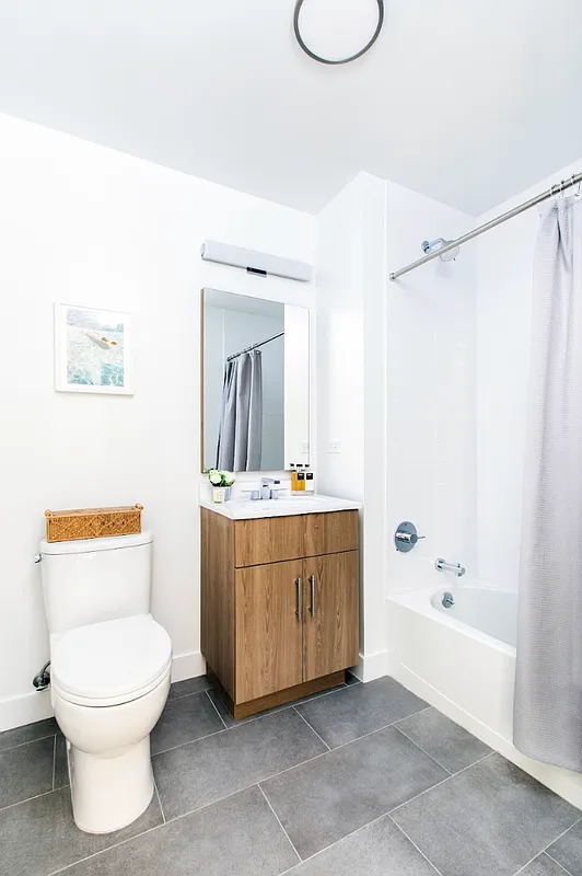 8 Palmetto Street, Unit 608 Brooklyn, NY 11221 - Photo 5 of 12 a bathroom with a toilet a sink and a bathtub