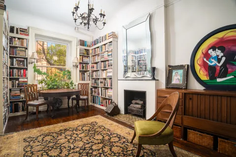 a living room with furniture a rug and a window