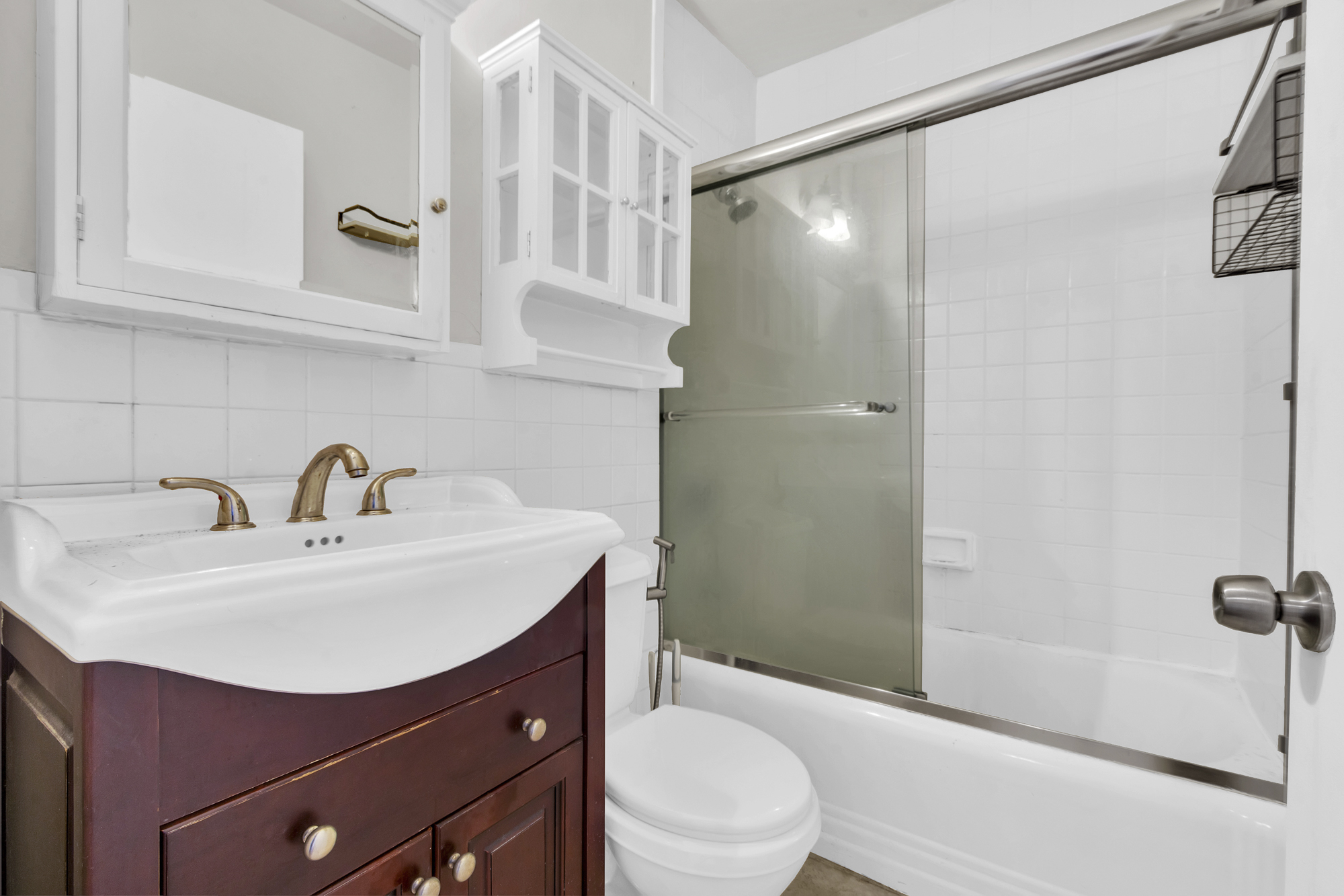 240 East 24th Street, Unit 2E Manhattan, NY 10010 - Photo 5 of 7 a bathroom with a sink toilet and shower