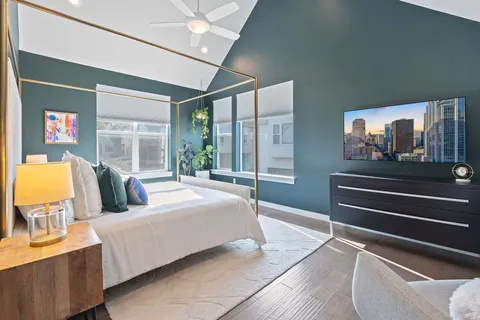 a bedroom with a bed and glass windows