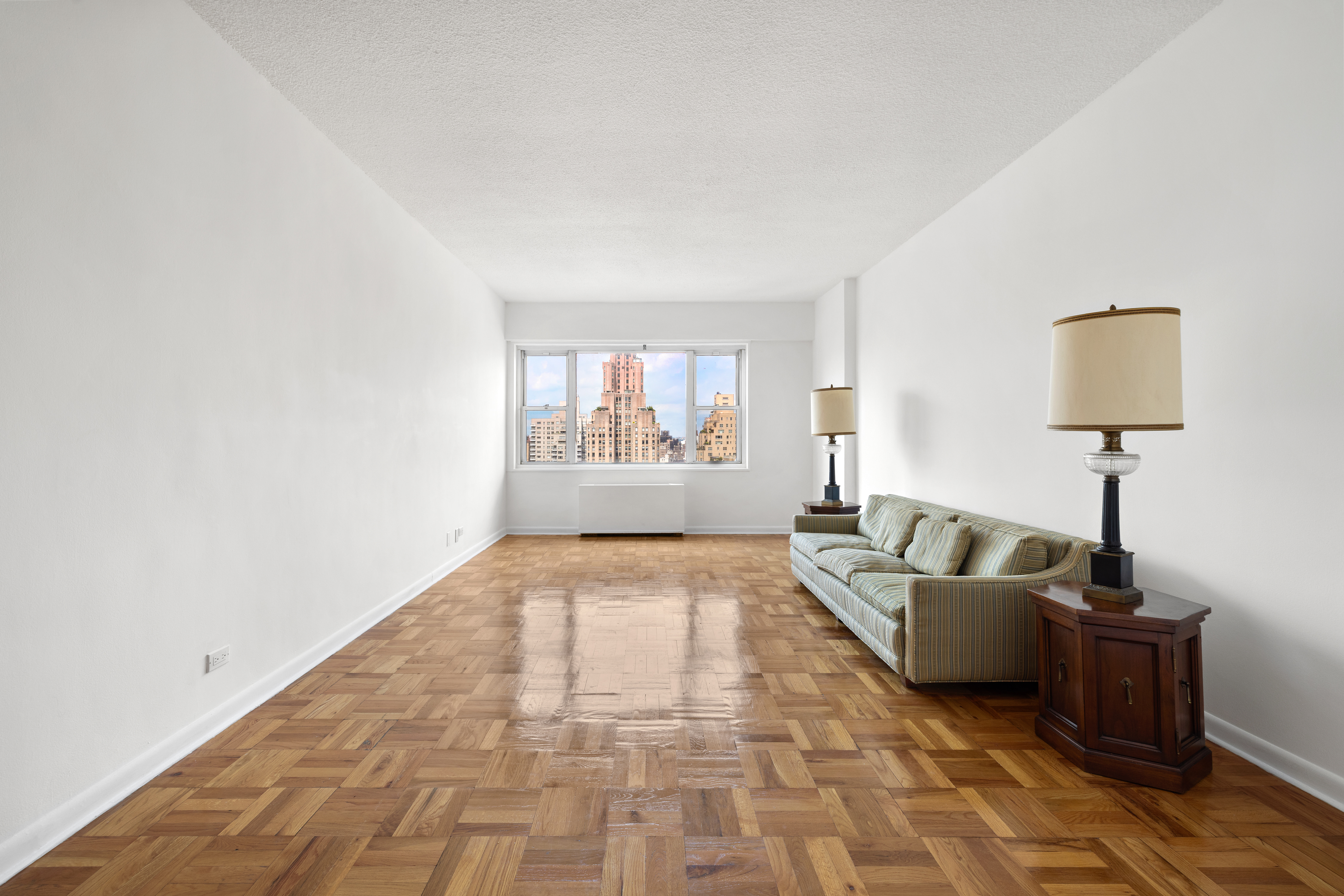 60 East 8th Street, Unit 15D Manhattan, NY 10003 - Photo 2 of 14 a living room with furniture and a window