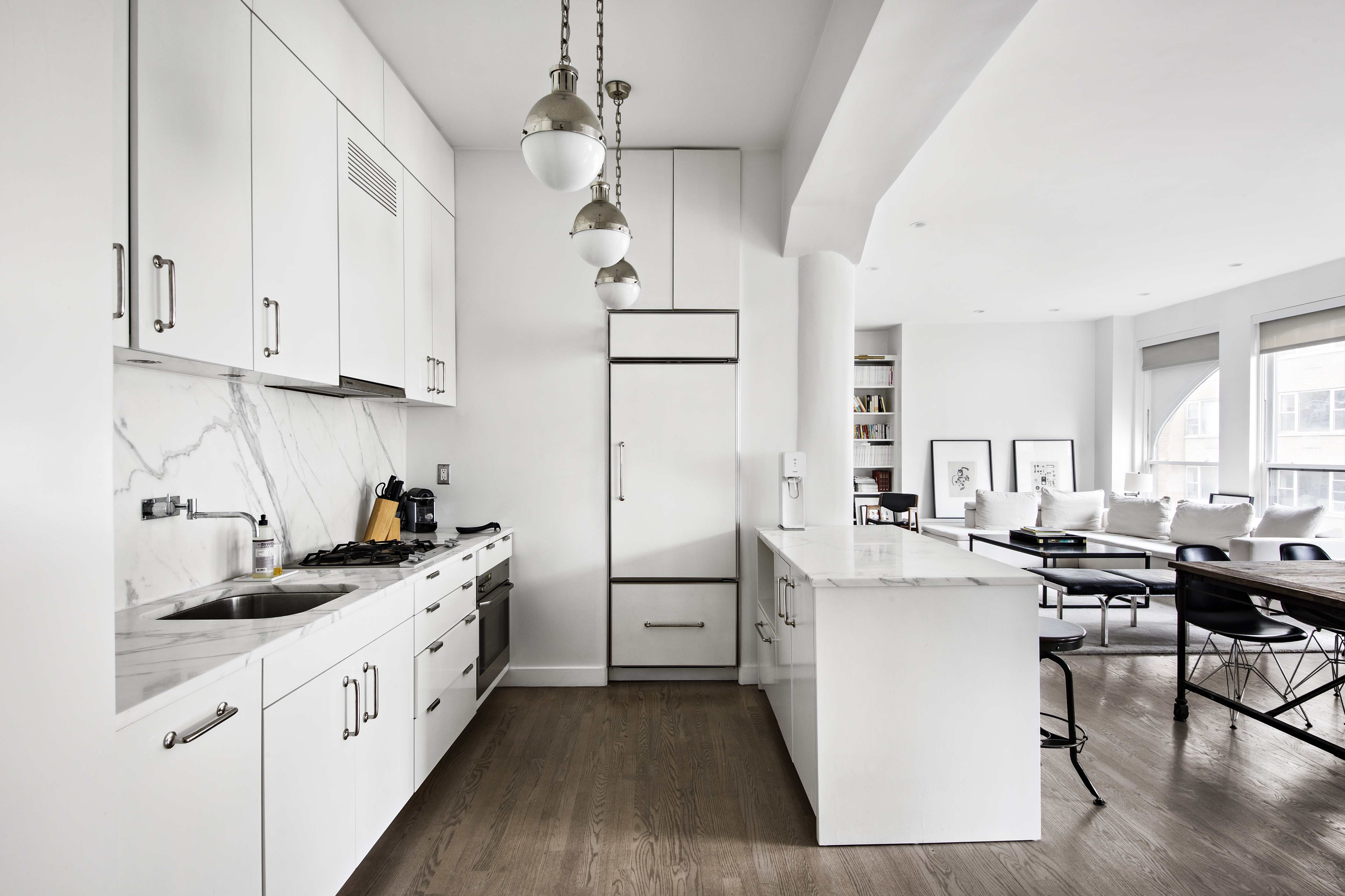 10 Bleecker Street, Unit 5D Manhattan, NY 10012 - Photo 4 of 8 a kitchen with white cabinets and white appliances