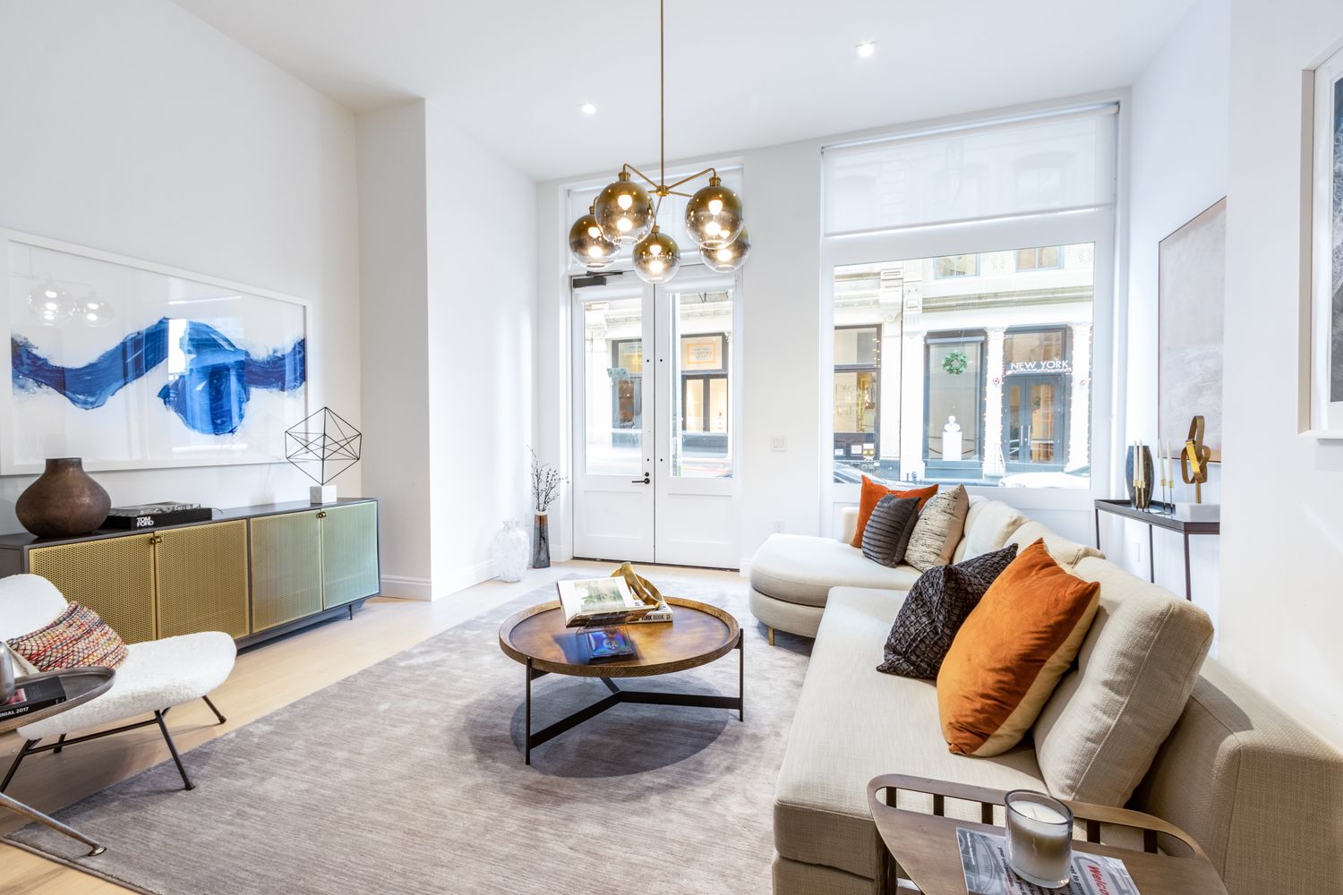 106 Franklin Street, Unit MAIS Manhattan, NY 10013 - Photo 12 of 16 a living room with furniture fireplace and a large window