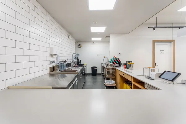 a kitchen with sink refrigerator and stove