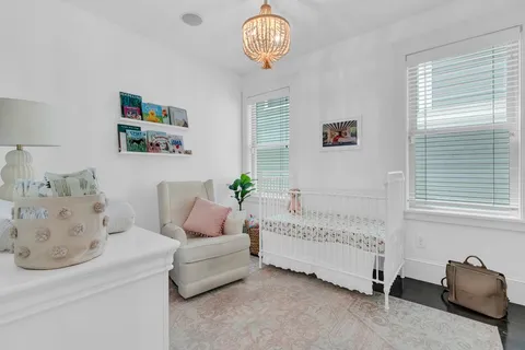 a bedroom with a bed and a chandelier