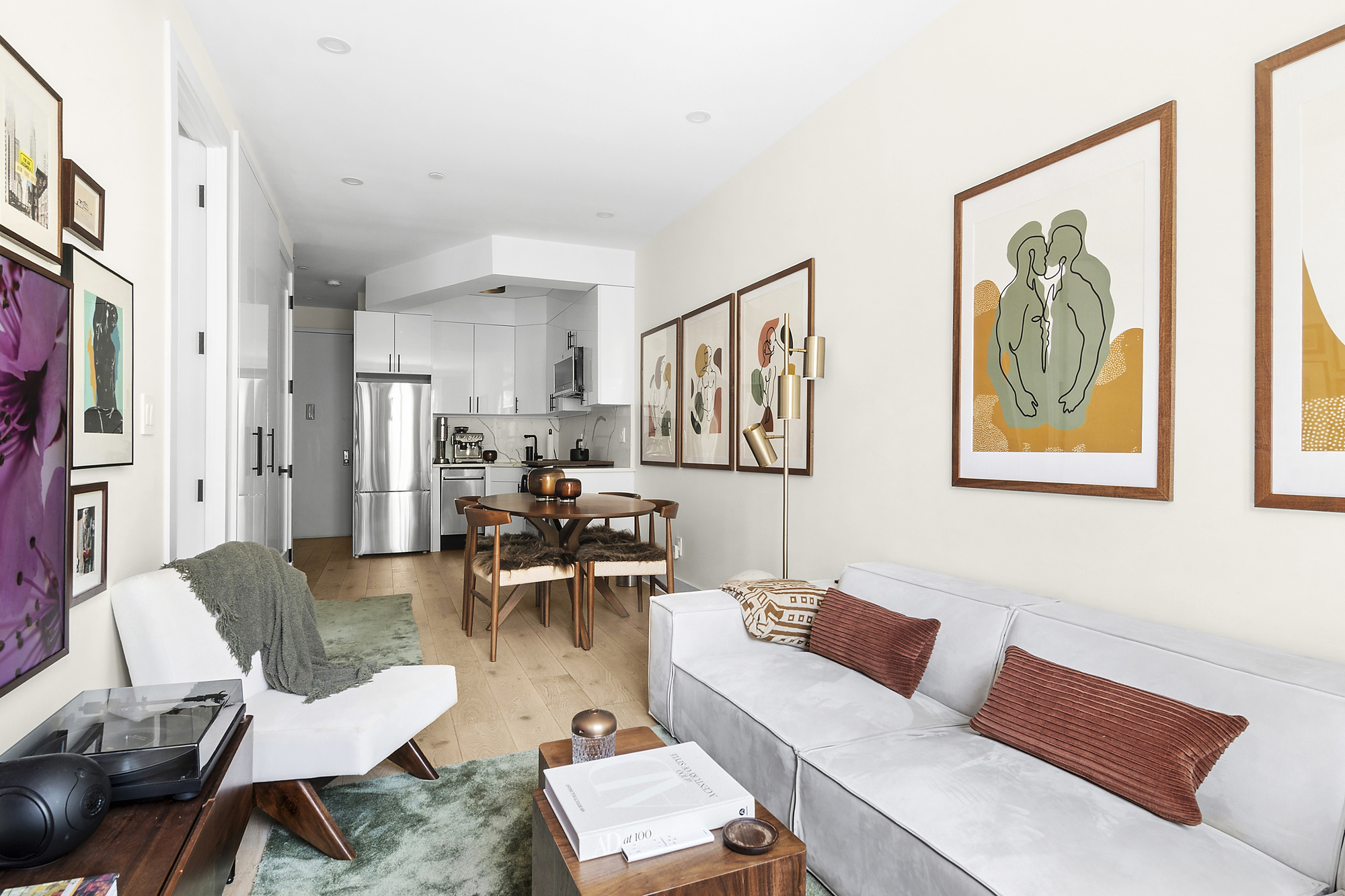 a living room with furniture and a painting