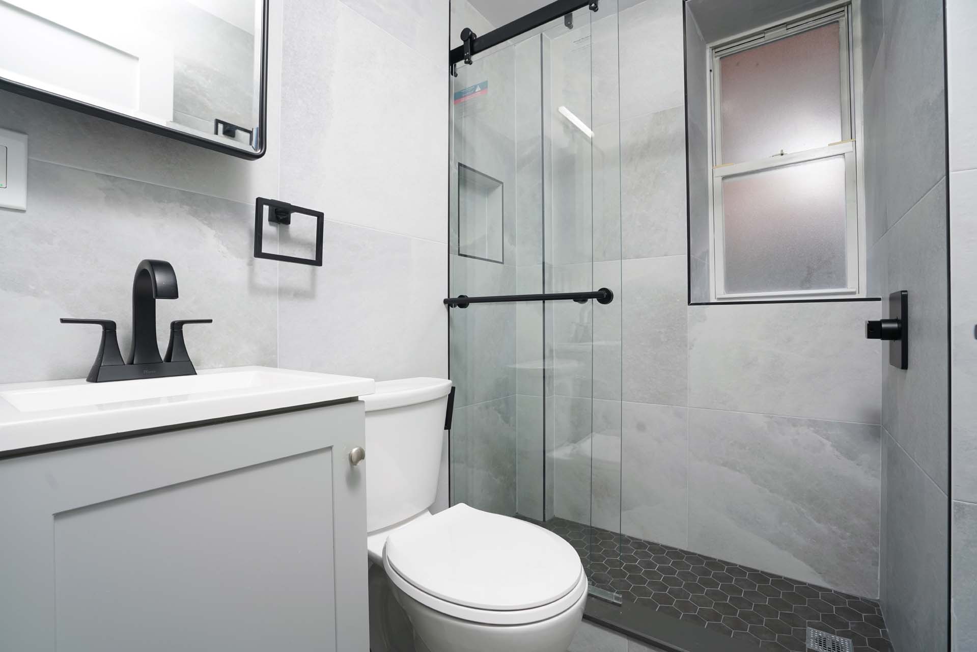 210 West 10th Street, Unit 1C Manhattan, NY 10014 - Photo 5 of 6 a bathroom with a sink a toilet and shower