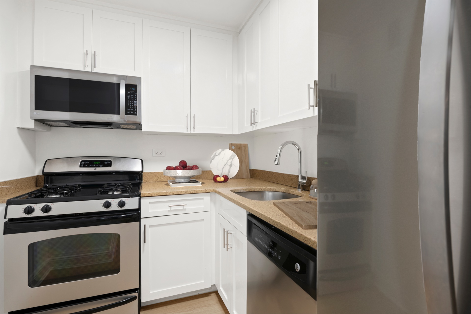 10 West 15th Street, Unit 414 Manhattan, NY 10011 - Photo 5 of 16 a kitchen with a stove and a microwave