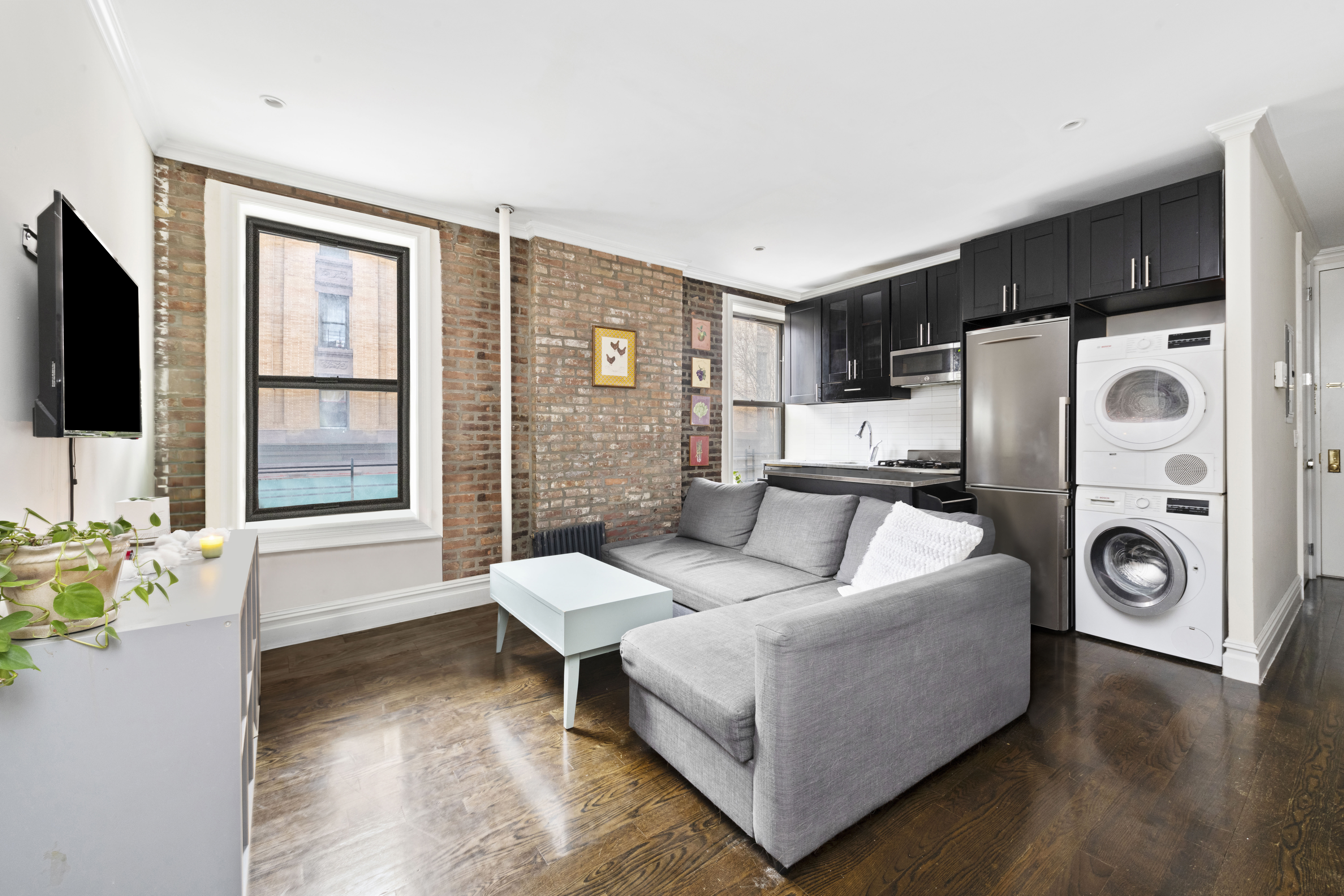170 West 83rd Street, Unit 2W Manhattan, NY 10024 - Photo 1 of 10 a living room with furniture and a flat screen tv