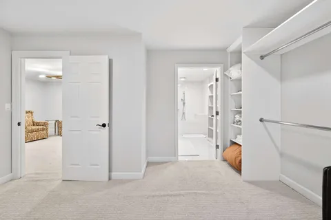 a view of a livingroom with wooden floor and white doors