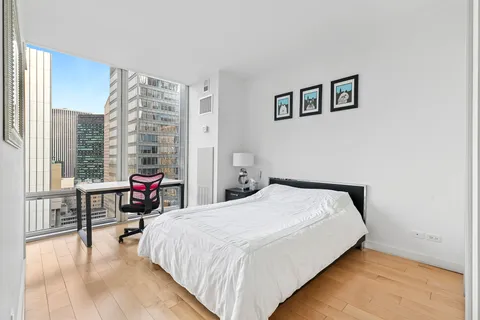 a bedroom with a bed and a table