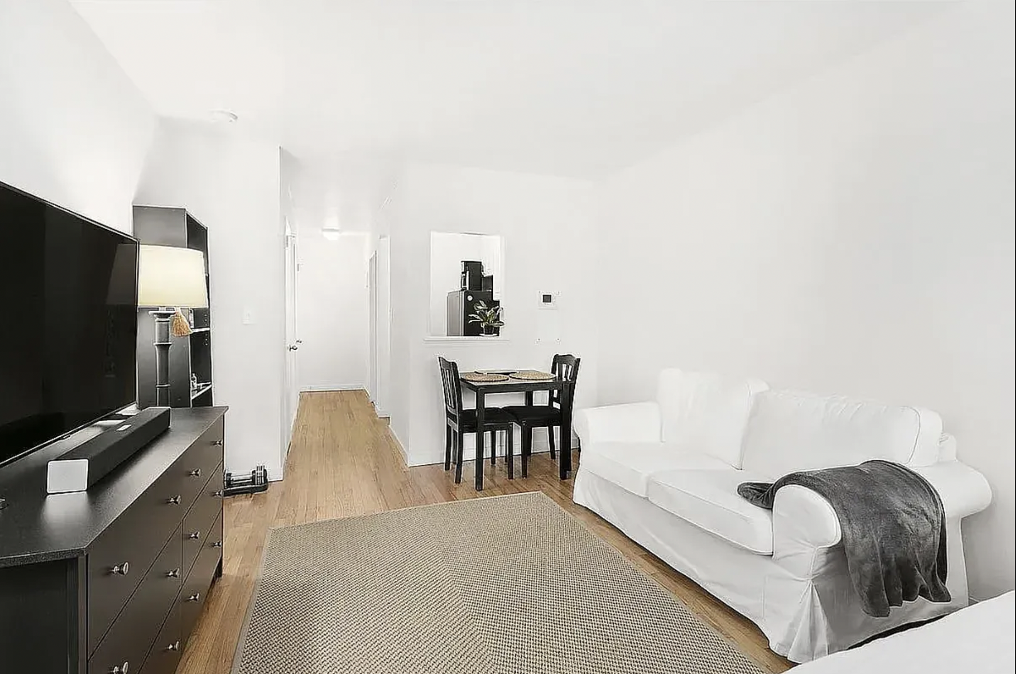 343 East 76th Street, Unit 2A Manhattan, NY 10021 - Photo 2 of 9 a living room with furniture and a flat screen tv
