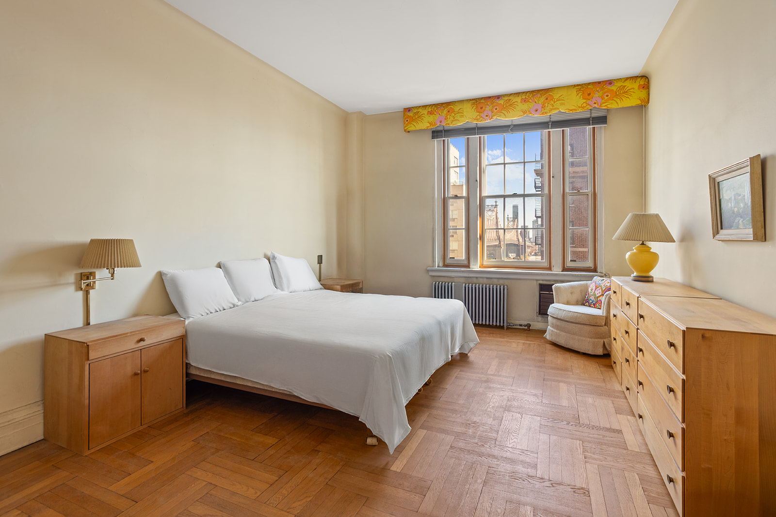 30 Sutton Place, Unit 12E Manhattan, NY 10022 - Photo 4 of 8 a spacious bedroom with a bed and wooden floor