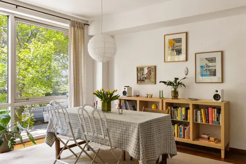 a bedroom with furniture and a book shelf