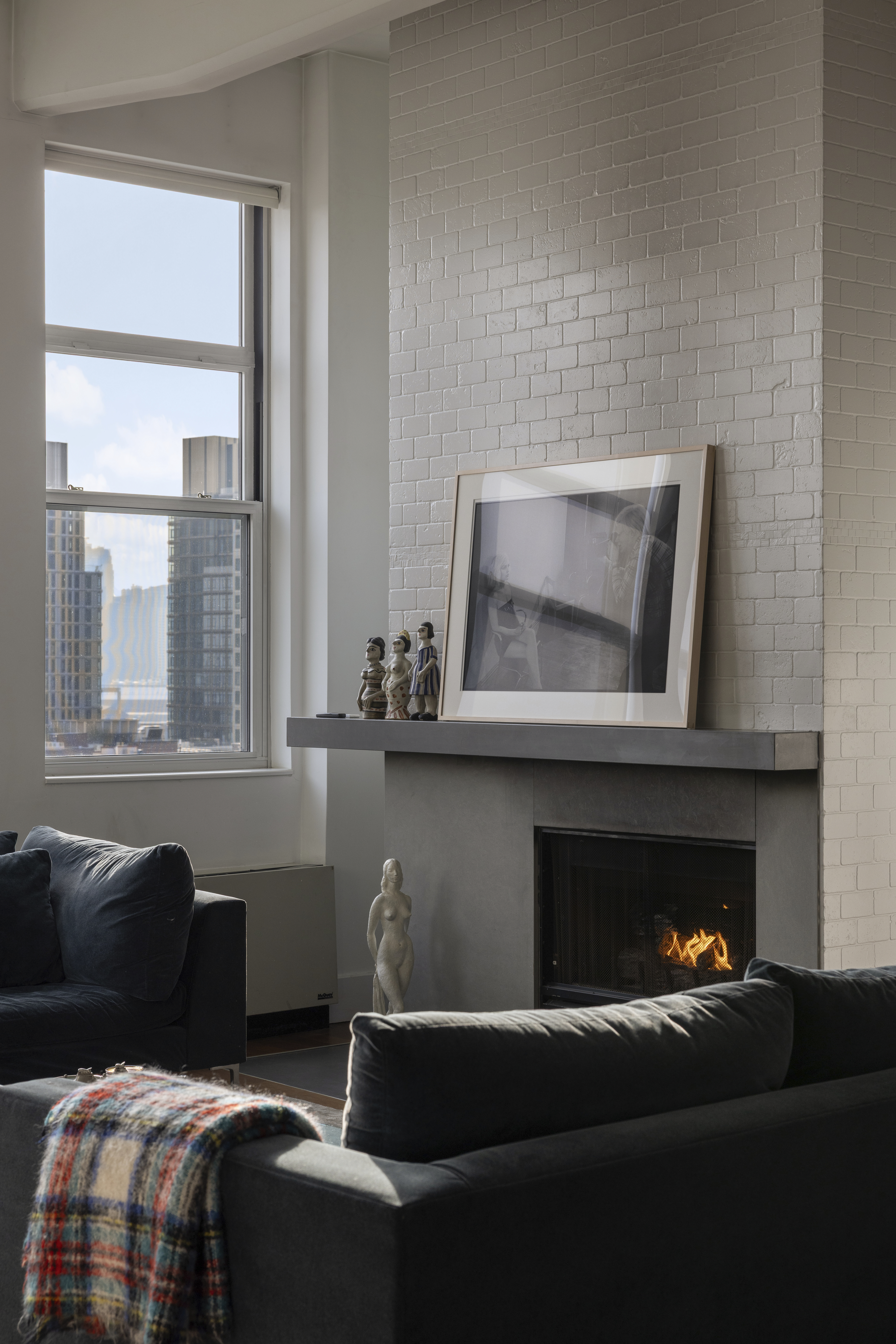 60 Broadway, Unit 8K Brooklyn, NY 11249 - Photo 3 of 10 a living room with furniture and a fireplace