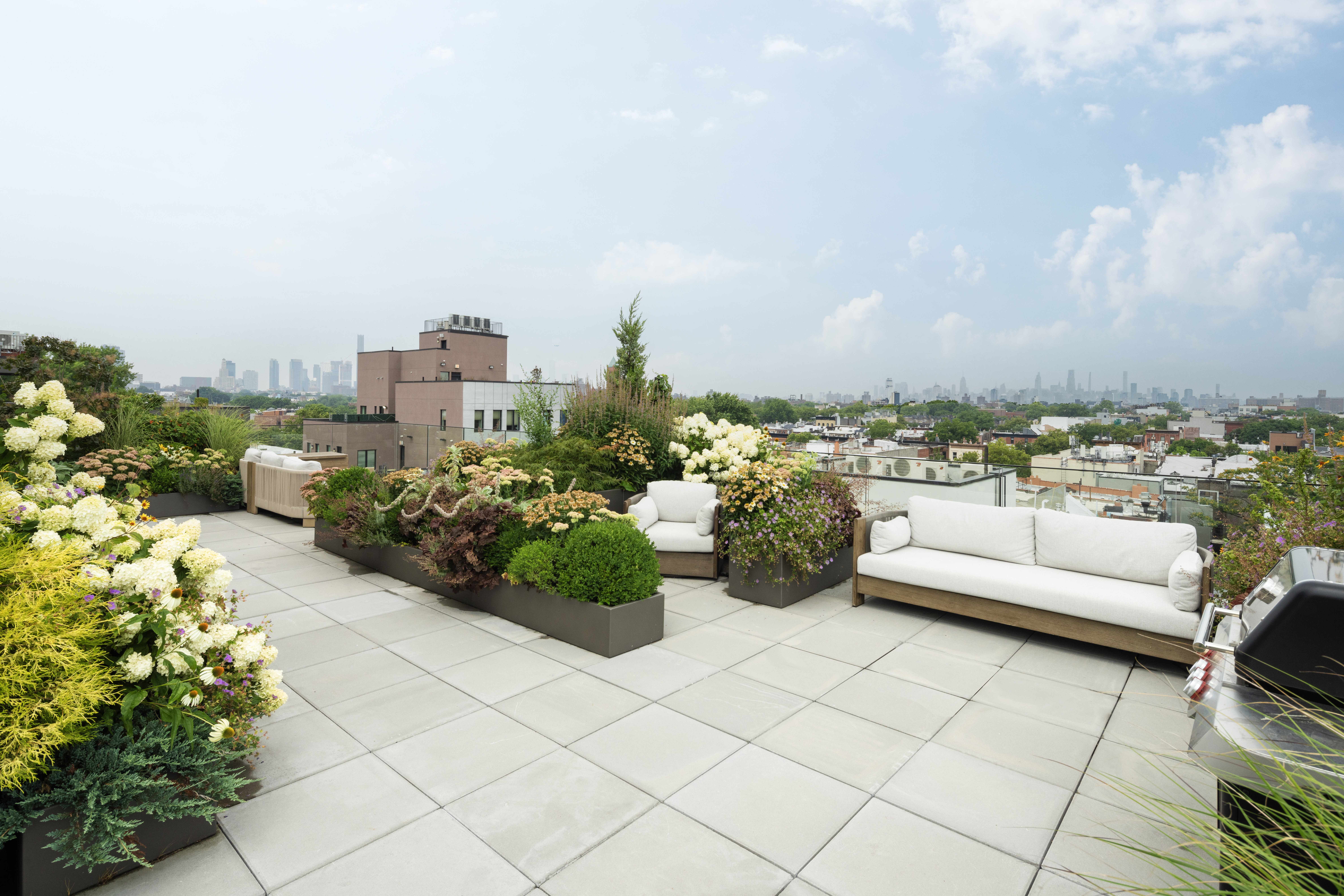 435 Tompkins Avenue, Unit PH505 Brooklyn, NY 11216 - Photo 9 of 14 a view of a terrace with couches and potted plants