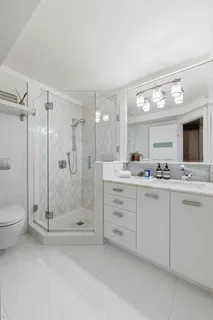 a bathroom with a shower a sink and a mirror
