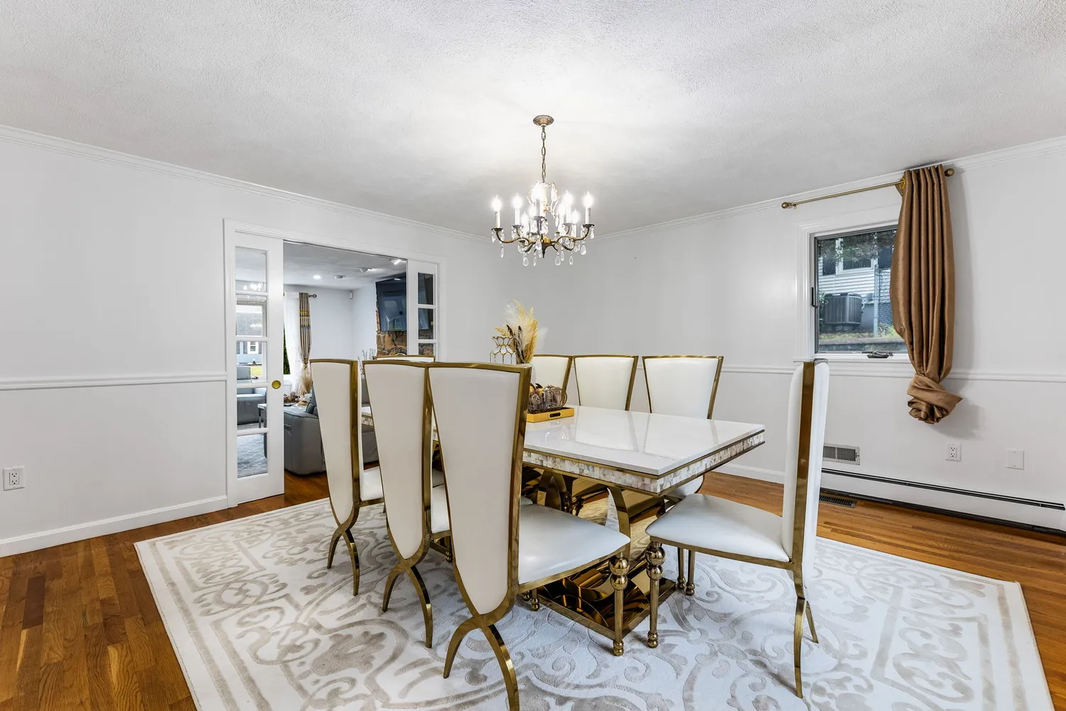 a view of a dining room with furniture and chandelier