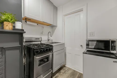 a kitchen with granite countertop a stove and a microwave