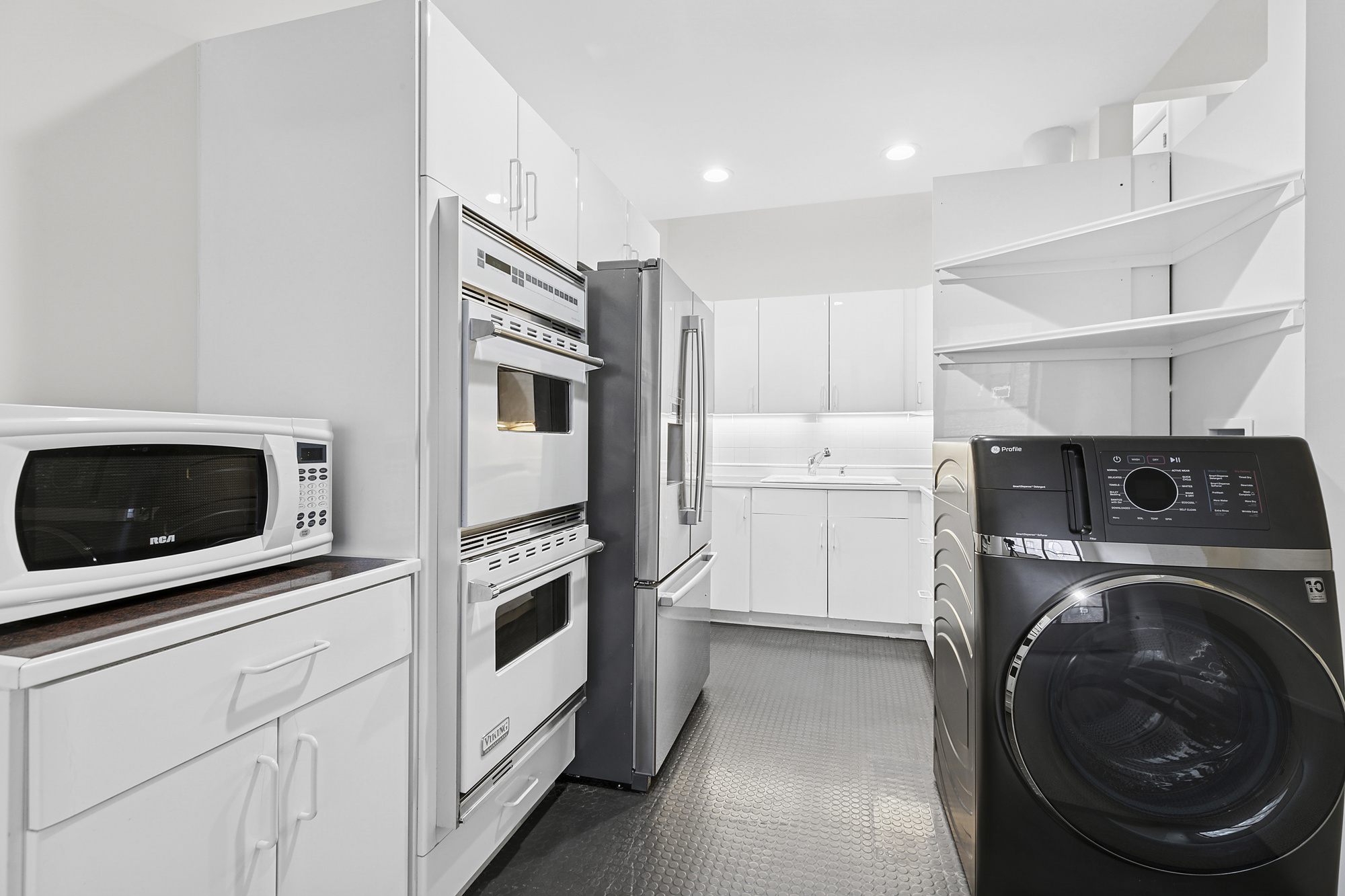 215 West 22nd Street, Unit 2 Manhattan, NY 10011 - Photo 6 of 8 a kitchen with a washer and dryer