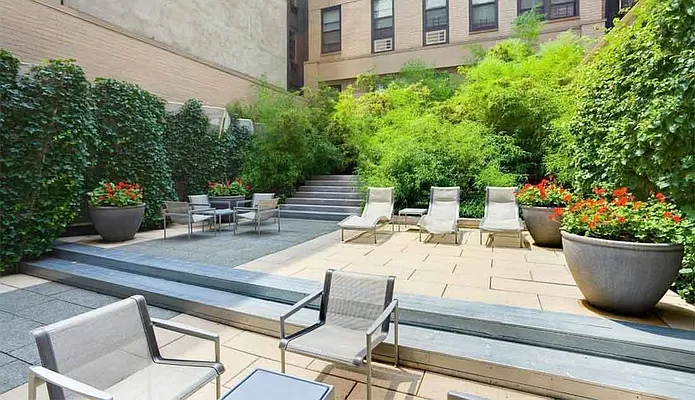 300 East 55th Street, Unit 28B Manhattan, NY 10022 - Photo 10 of 12 a view of a patio with table and chairs and potted plants