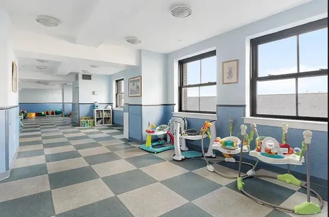 a living room with furniture and a dining table with kitchen view
