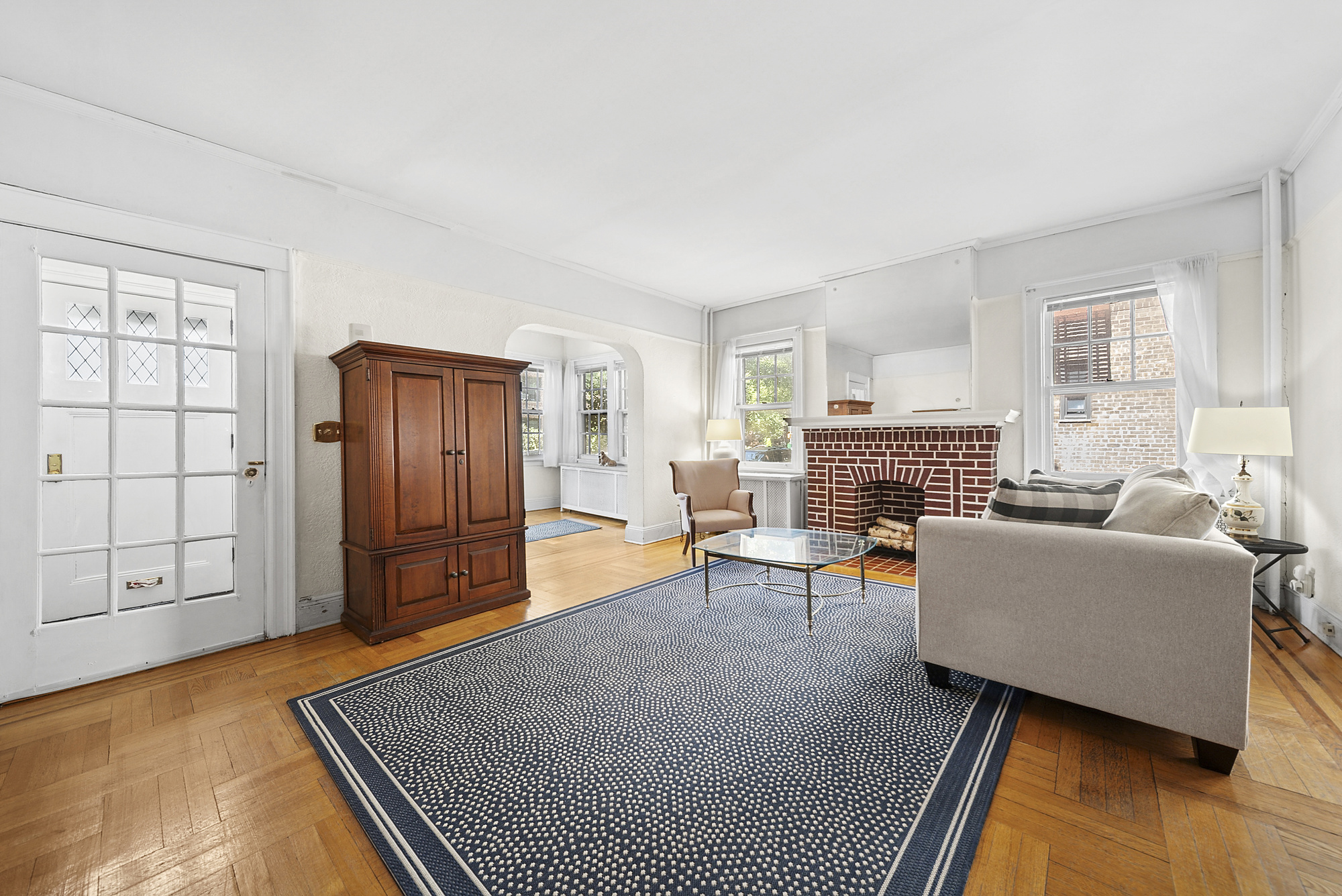 34-15 88th Street Queens, NY 11372 - Photo 2 of 15 a living room with furniture and a fireplace