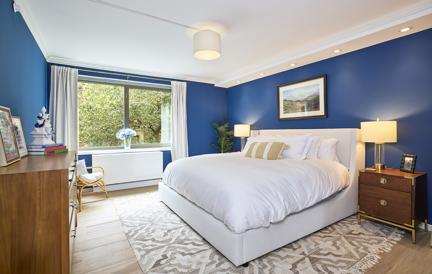 101 West 87th Street, Unit 205 Manhattan, NY 10024 - Photo 4 of 14 a bedroom with a bed and a large window with outer view