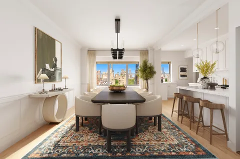 a dining room with furniture a rug a potted plant and a chandelier