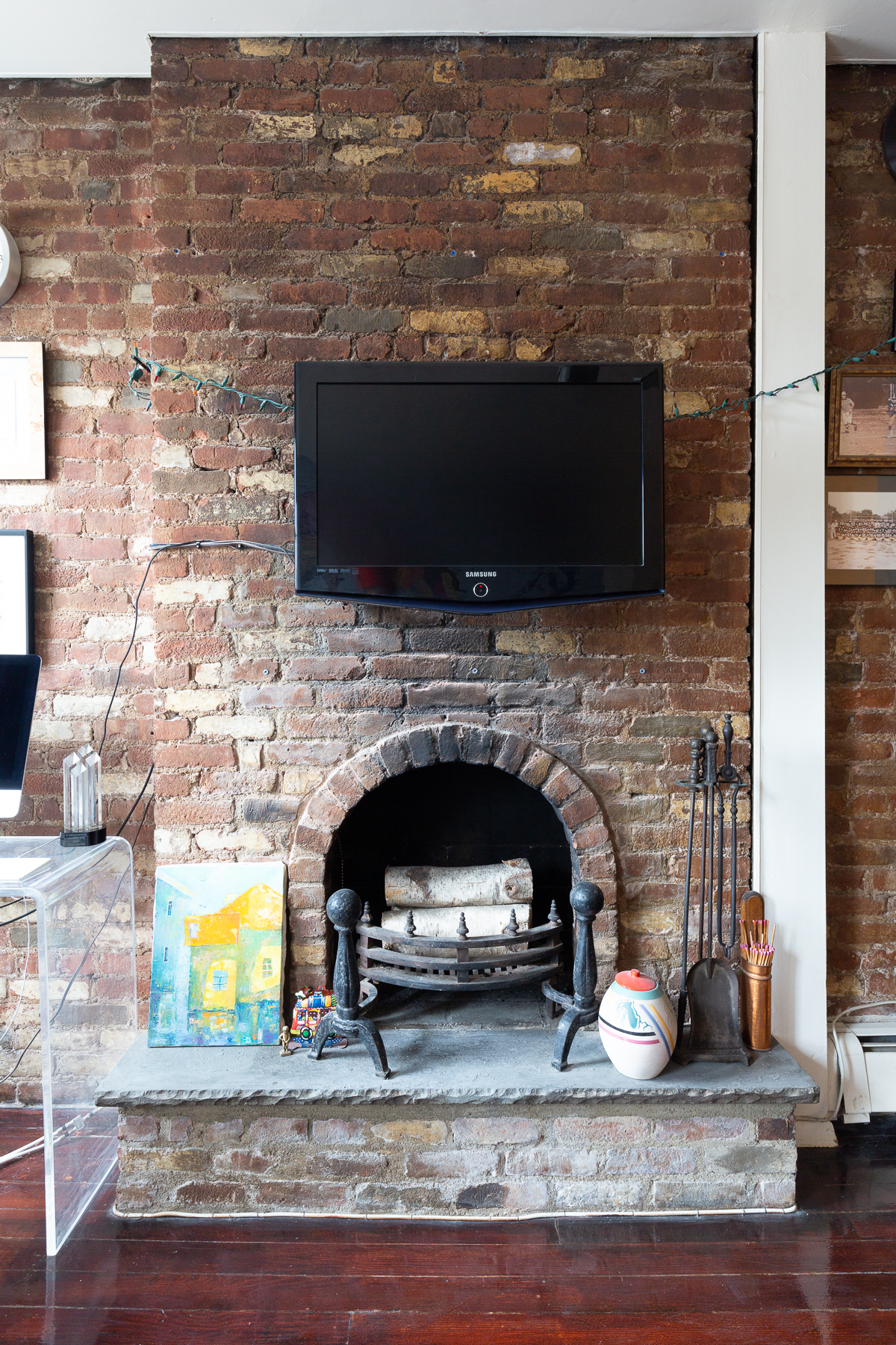 115 Charles Street, Unit 11 Manhattan, NY 10014 - Photo 6 of 7 a living room with a fireplace a flat screen tv and a fireplace