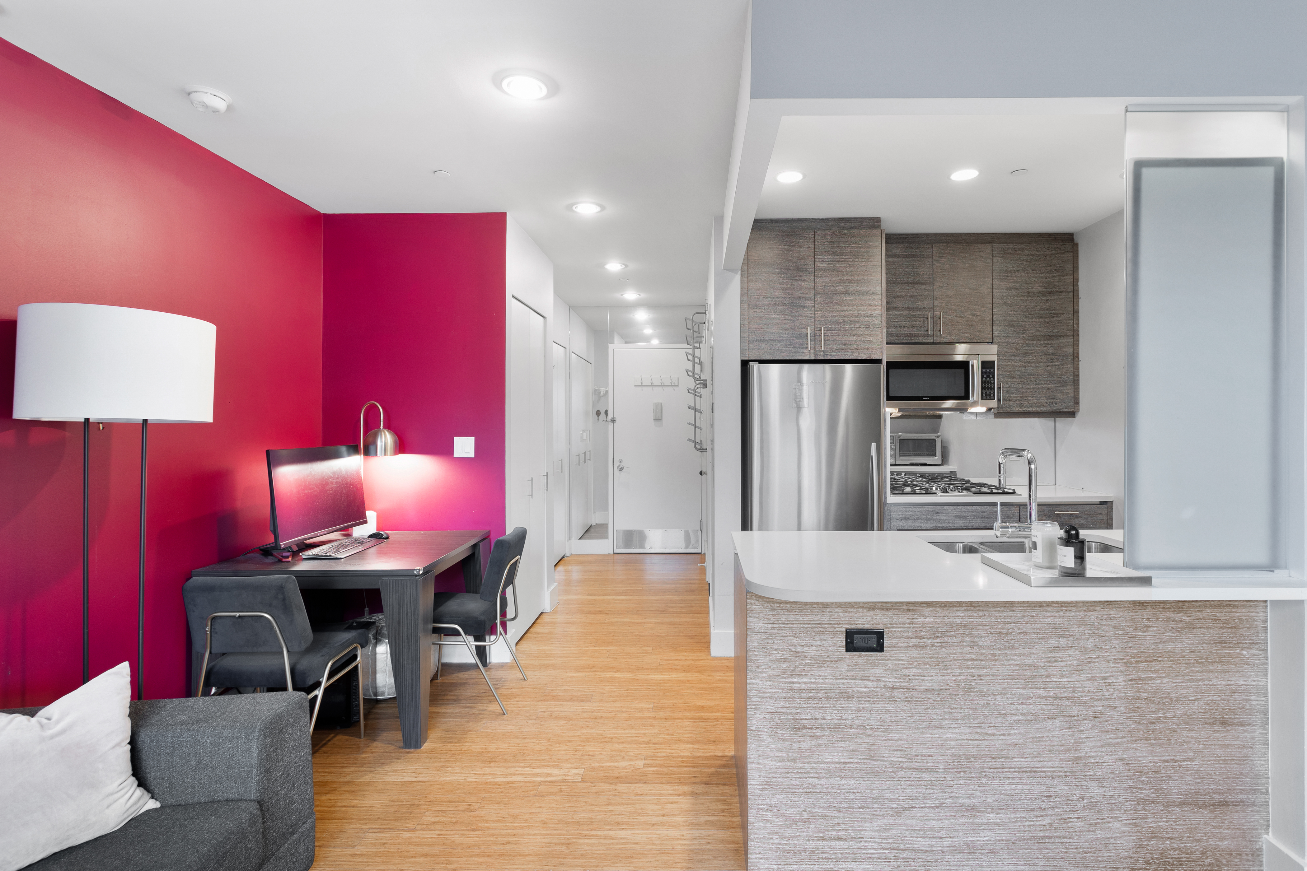 305 West 16th Street, Unit 5B Manhattan, NY 10011 - Photo 3 of 15 a kitchen with stainless steel appliances kitchen island granite countertop a sink a refrigerator and a stove
