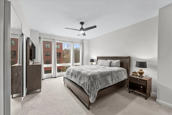 a spacious bedroom with a bed and a chandelier