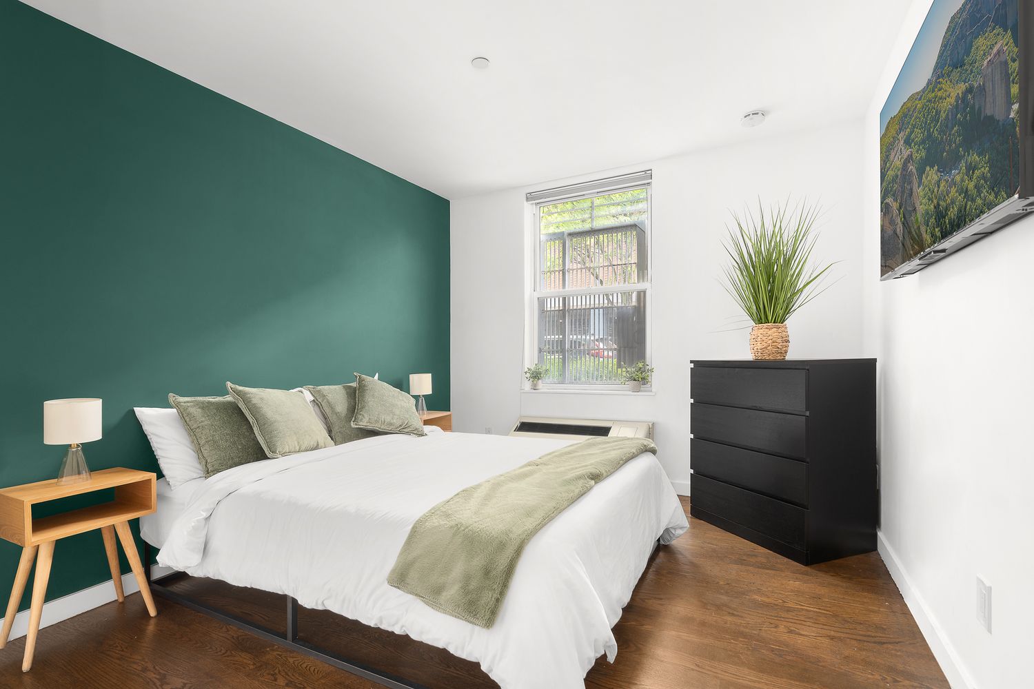 51 East 128th Street, Unit 1C Manhattan, NY 10035 - Photo 4 of 9 a bedroom with a bed and a potted plant