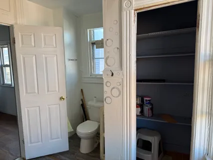 a bathroom with a toilet and a shower