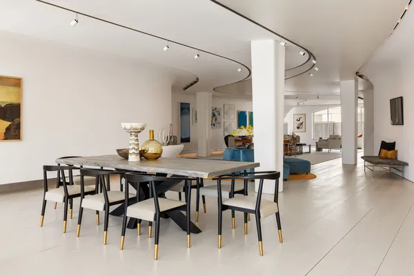 a view of a dining room with furniture and a chandelier