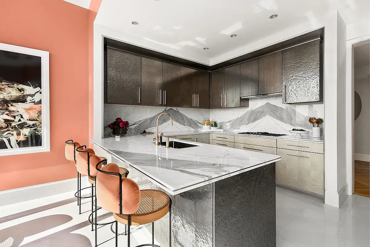 a kitchen with stainless steel appliances a sink and a refrigerator
